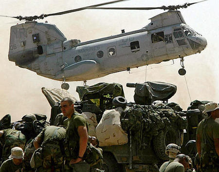 CH-46 Sea Knight helicopter flies over to deliver supplies for the U.S. 15th Marine Expeditionary Unit, a secret Marine base, southern Iraq desert, March 28, 2003.