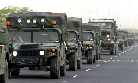A convoy of U.S. troops is about to cross Iraqi border, some place between Jahra and Salmy, western Kuwait, March 26, 2003.