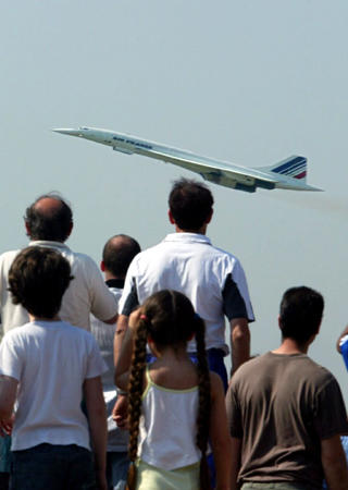 Plane spotters watch the Concorde, Flight AF002, take off for the last time from Paris's Roissy-Charles de Gaulle airport, May 30, 2003. After flying between the United States and France since 1976, the supersonic passenger jet will make its last commercial flight for Air France when it leaves New-York's JFK airport for Paris-Charles de Gaulle at 8 AM tomorrow!