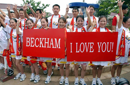 Chinese soccer fans welcome David Beckham and Real Madrid players, Kunming Airport, China, July 25, 2003.