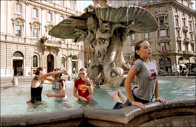 Girls cooled off in Piazza Barberini, Rome, August 9, 2003.