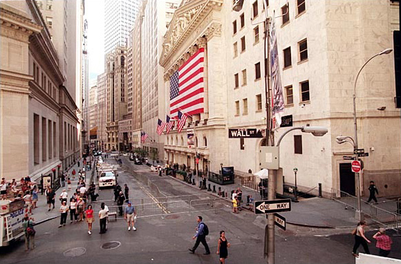 Generator trucks sit outside the American Stock Exchange, the nearly empty of traffic intersection of Wall Street and Trinity Place, New York, August 15, 2003.