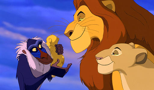 Rafiki, holds the lion cub Simba as his parents, Mufasa and Sarabi, look on in a scene from animated film The Lion King (1994).