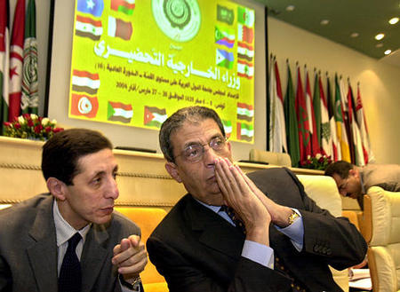 Amr Moussa, secretary general of the Arab League, right, listens to his aid, Hesham Youssef, during the second day of the Arab foreign ministers preparation meeting, Tunis, March 27, 2004.