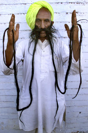Villager Badamsinh Juwansinh Gurjar displays his 12.5-foot-long moustache, Ahmedabad, western India, February 29, 2004.