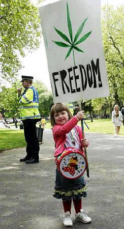 A young girl holds a banner during the Fifth Annual International Cannabis March, London, May 2003.
