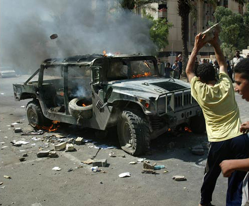 Sunni young men celebrate after a roadside bomb destroyed a U.S Humvee, Baghdad, October, 2003.