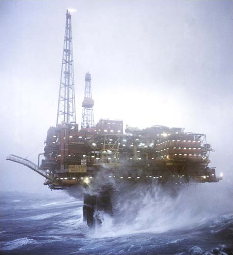 A Shell-Esso oil platform is buffeted by high wind and waves, the North Sea off the coast of Scotland, circa December 2003.
