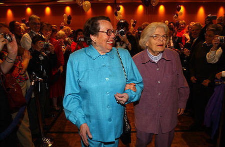 Longtime gay activists, Phyllis Lyon and Del Martin, the first couple to be married after San Francisco Mayor Gavin Newsom allowed same-sex marriages, walk to the stage during a reception for recently wed same-sex couples, San Francisco, February 22, 2004.