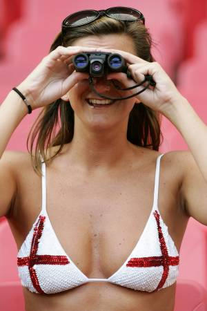 A supporter wearing an England's Saint George flag bra watches from the stands ahead of their Euro 2004 Group B soccer match against Croatia at the Luz Stadium in Lisbon, June 21, 2004.