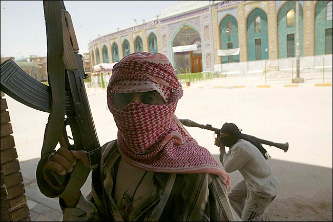 Fighters from the Mahdi Army, followers of the Shia cleric Muqtadah a-Sadr, take up positions around the shrine of Imam Hussein in the center of Karbala as they fight against US troops trying to dislodge them from the city, May 16, 2004.