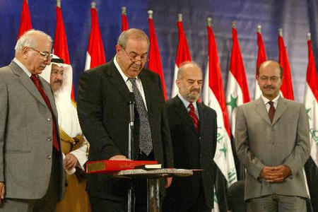 Iraqi Prime Minister Iyad Allawi, is sworn in to office, surrounded from left to right by Iraqi Chief Justice Medhat al-Mahmoudi, President Ghazi al-Yawer, Vice President of Iraq Ibrahim Al-Jaafari, and Deputy Prime Minister Barham Saleh, Baghdad, Iraq, June 28, 2004.