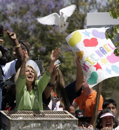 A woman releases a dove after each 'not guilty' on the 10 counts in the child molestation and conspiracy case against Michael Jackson who was finally acquitted of all charges, outside Santa Barbara County Superior Court, Santa Maria, California, June 13, 2005.
