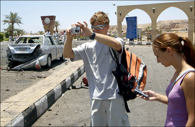 Just a day after the explosions, visitors, undeterred by terrorist attacks, enjoy photographing of attacked sites, Sharm A-Sheik, July 25, 2005.