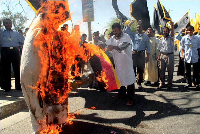 Iraqis burn an effigy of Pope Benedict XVI during a protest in Basra, September 18, 2006.