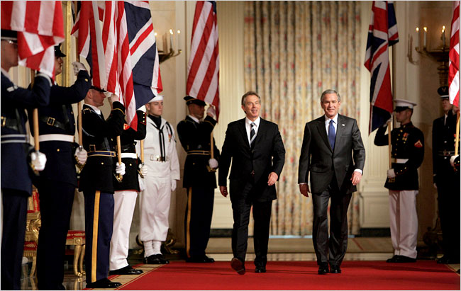 U.S. President George W. Bush walks with British Prime Minister Tony Blair to a joint press conference in the East Room of the White House, July 28, 2006.