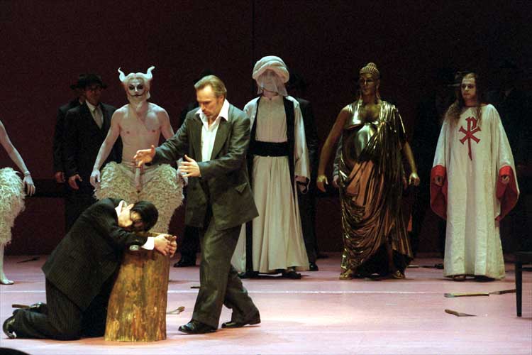 Characters representing various religious leaders, Poseidon, Jesus, Buddha and Muhammad, stand in the background, in this 2003 rehearsal scene of Mozart's opera 'Idomeneo,' where the King of Crete, is played by Charles Workmann (front center).