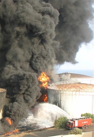 A fuel tank burns in Jiyeh after being attacked by Israeli missiles in south Beirut as a part of Israeli air raids that shooked Beirut on the fifth day of a devastating assault on Hezbollah, July 16, 2006.