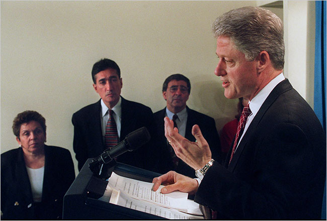 Bill Clinton, during a Presidential speech, flanked by his staff, from left, Secretary of Health and Human Services Donna Edna Shalala, Secretary of Housing and Urban Development Henry G. Cisneros, and White House Chief of Staff Leon Panetta, 1990s.