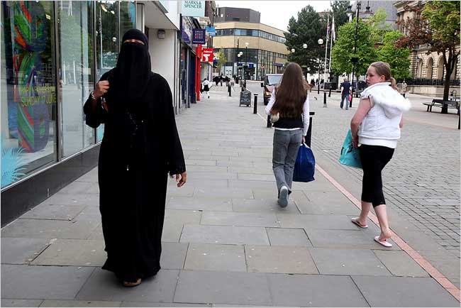 A woman identified only as Ms. Mayata walks through one of London streets, only to be stopped and asked Why do you wear that?' or receive other rude comments about her niqab, London, June 2007.