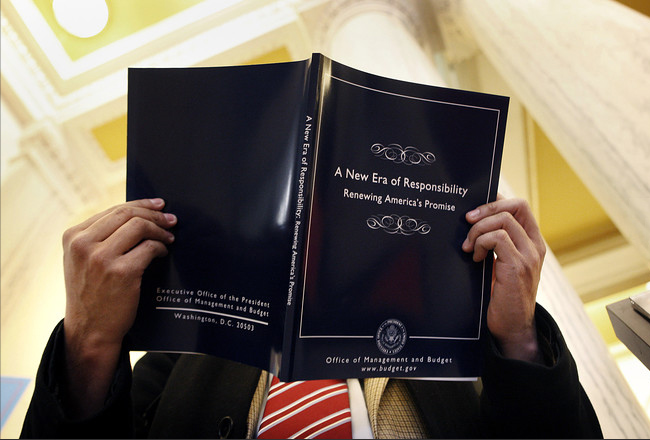 Humberto Sanchez, from Congress Daily, read over a copy of President Obama's first budget for fiscal 2010 at the U.S. Government Printing Office, Washington, February 28, 2009.