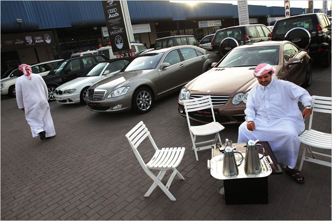 A car salesman sits without customers as lack of credit and a glut of cars on the market are cutting sales, Dubai, February 11, 2009.