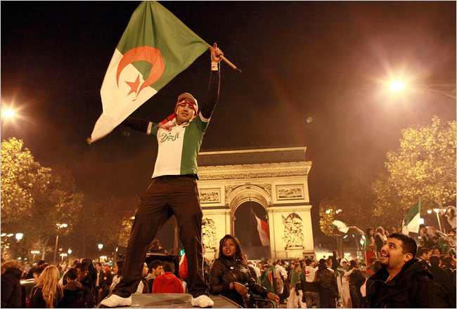 Supporters of Algeria's national soccer team celebrate near the Arc de Triomphe after their win over Egypt in Khartoum, Paris, November 18, 2009.