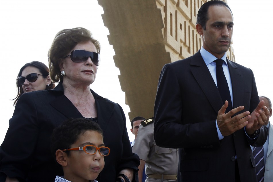 Gamal Mubarak (R), the son of Egypt's President Hosni Mubarak and head of the Higher Political Committee of the National Democratic Party (NDP), prays with Jehan a-Sadat, the widow of late former President Anwar a-Sadat, at Sadat's tomb during his 29th death anniversary, Cairo, October 6, 2010.