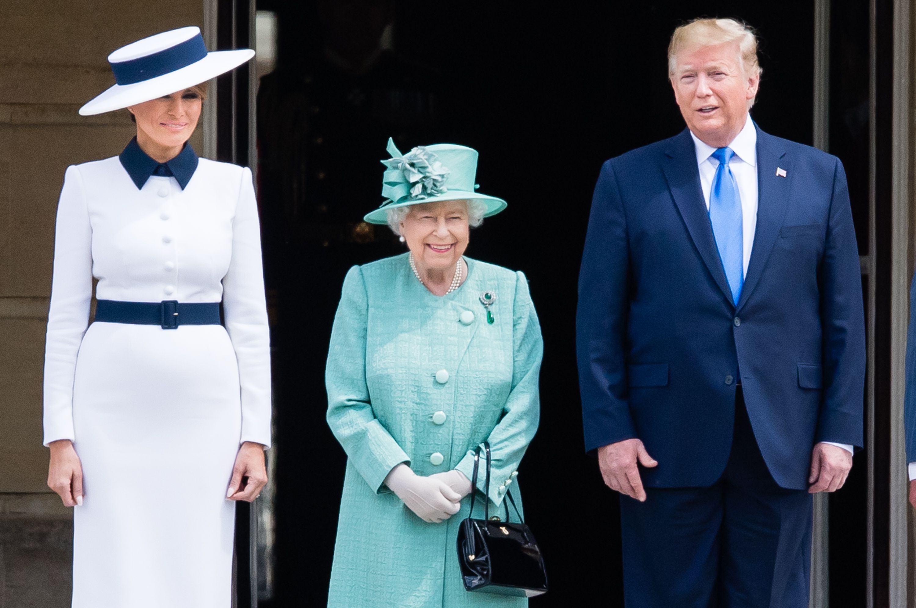US First Lady Melania Trump, Britain's Queen Elizabeth II and US President Donald Trump pose for a photograph during a ceremonial welcome in the garden of Buckingham Palace on the opening day of a three day state visit to Britain, London, June 3, 2019.