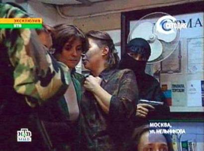 Russian NTV image of a pistol wielding Chechen female terrorist and a group of hostages, Palace of Culture for the Moscow Ball-Bearing Factory, October 24, 2002.