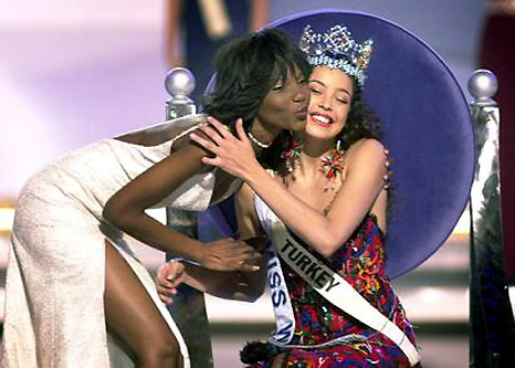 The newly crowned Miss World Miss Turkey, Azra Akin, receives a congratulation kiss from last year's winner Miss Nigeria, Agbani Darego, London, December 7, 2002.