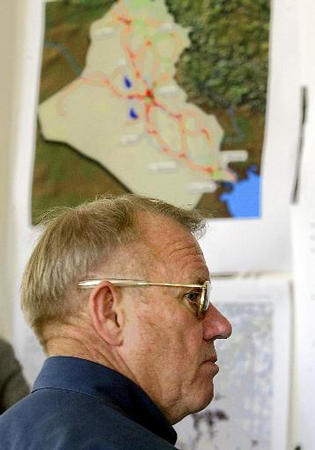 Retired US Lt. General Jay Garner, stands under a map of Iraq as he listens to a briefing on the power situation, Baghdad's southern power station, April 21, 2003.