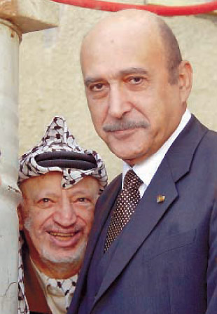 Palestinian leader Yasser Arafat, looks on behind Egyptian intelligence chief Omar Suleiman, Ramallah, December 14, 2002.