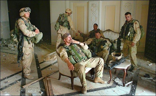 U.S. Army Stf. Sgt. Chad Touchett, relaxes with comrades inside Saddam's main palace, Baghdad, April 7, 2003.