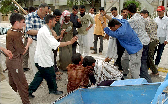 Crowd attacks a man accused of being a paramilitary, Baghdad, April 8, 2003.