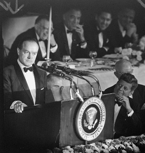 President John F. Kennedy, looks up toward comedian Bob Hope, Waldorf-Astoria Hotel, New York, May 30, 1961.