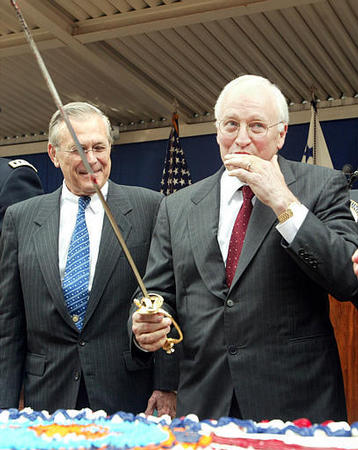 Vice President Dick Cheney licks off his finger, after cutting the Army's 228th birthday cake with Secretary of Defense Donald H. Rumsfeld, June 13, 2003.