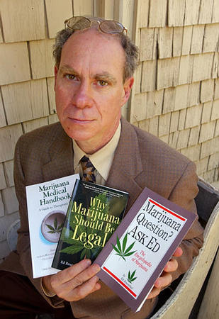 The self-proclaimed Guru of Ganja, Ed Rosenthal, poses with three of his books he wrote, at his home, Oakland, California, June 3, 2003.
