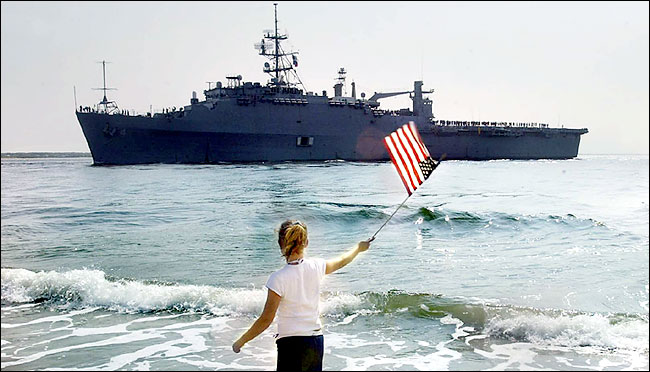 A girl greets amphibious ship Austin bringing marines home from the Persian Gulf, Morehead City, North Carloina, May 26, 2003.