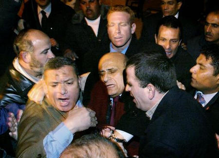 Egyptian Foreign Minister Ahmed Maher faints as he is whisked out of the al-Aqsa compound in Jerusalem's Old City by bodyguards, December 22, 2003.