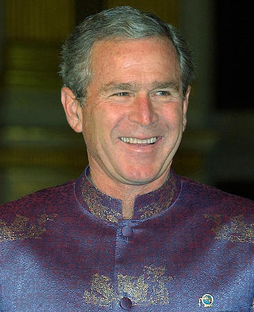 Dressed in specially tailored Thai silk shirts, U.S. President Goerge W. Bush smiles during a photo session of the APEC leaders, Bangkok, October 21, 2003.
