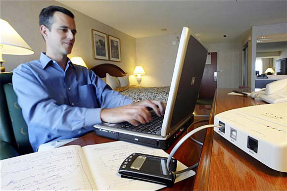 Rob Meinhardt, the chief of Kace Networks, tests the high-speed Internet link, a San Francisco hotel, July 2003.