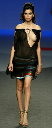 A model displays an outfit created by designer Elio Berhanyer during the Spring-Summer 2004 Pasarela Cibeles fashion week, Madrid, September 24, 2003.