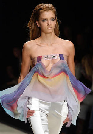 A strapless chiffon top is shown with white satin pants at the Paola Frani Spring-Summer 2004 fashion collection, Milan, Italy, Septemebr 30, 2003