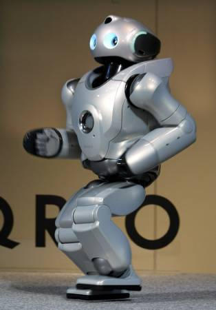 World's first running humanoid robot, Sony Corp's humanoid robot Qrio runs at 'its' unveiling, Tokyo, December 18, 2003.