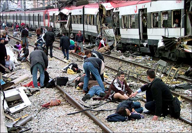 Rescue workers attended to some of the victims of the explosions on four commuter trains, Madrid, March 11, 2004.