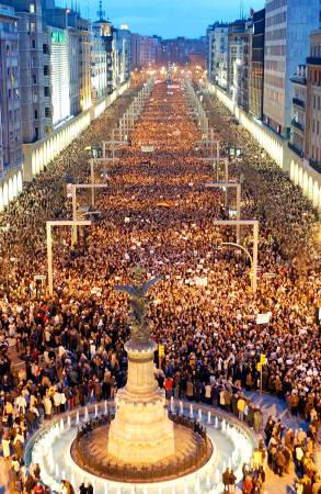As millions of grieving Spaniards poured into the streets crying cowards and killers, Spanish protestors gather for a silent march through Zaragoza, March 12, 2004.