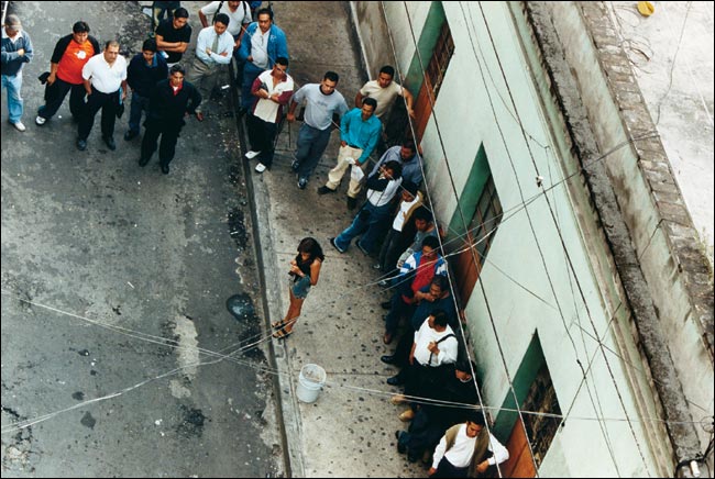 A sex worker paraded near a brothel, Calle Santo Tomas, La Merced, Mexico, January 2004.