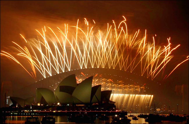 The Sydney Harbour Bridge and Opera House are backdropped by fireworks during New Year celebrations, Janyary 1, 2004.