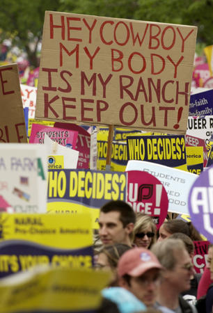 A demonstrator holds up a sign referring to U.S. President George W. Bush as hundreds of thousands of protesters rally for abortion and protecting women's reproductive rights, the National Mall, Washington, April 25, 2004, 